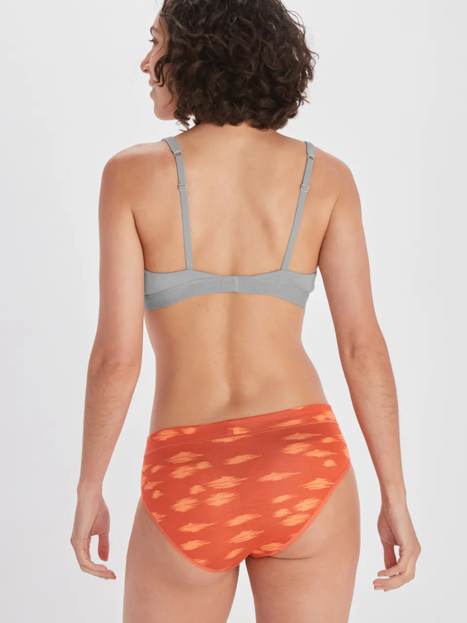 backside of women's brief and bra on model